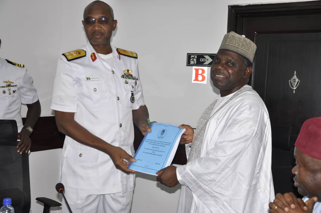 Rear Admiral Hamza Ibrahim receives the handover documents from Rear Admiral Zakariya Shaku Muhammad during the Navy Holdings Limited leadership transition ceremony in Abuja.