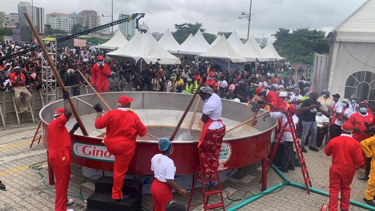 Hilda Baci celebrating after cooking 8,780kg of jollof rice to break the Guinness World Record at the World Jollof Festival in Lagos.