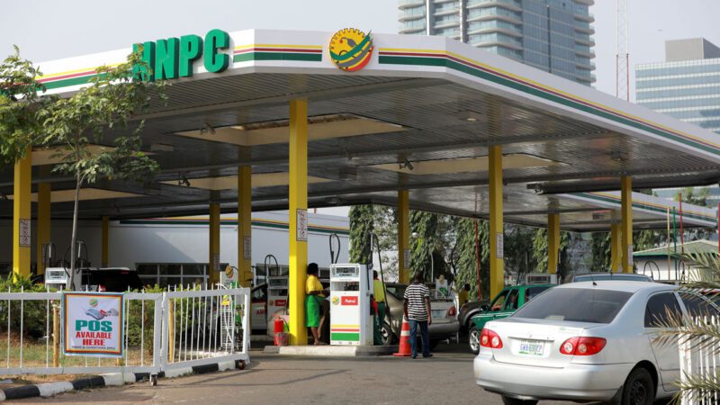 Fuel attendants adjust pump meters as NNPCL raises petrol price to ₦992 per litre across Nigeria.
