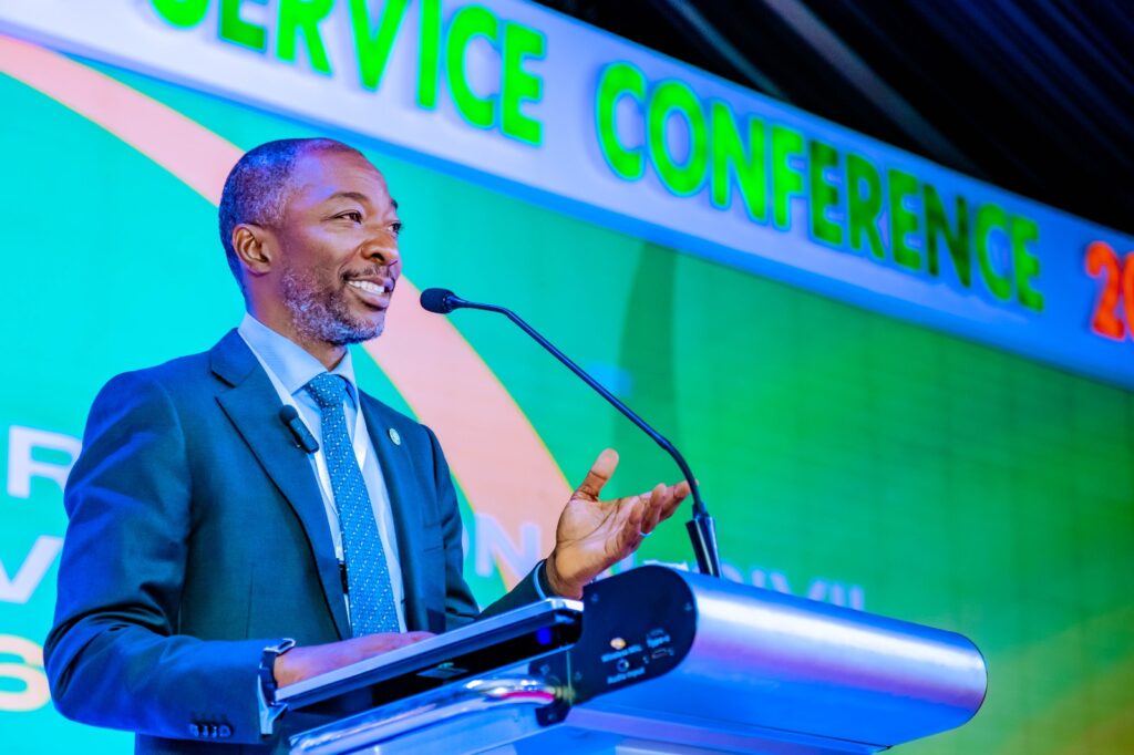 NSITF officials speaking at a public service conference in Abuja on workplace safety and protection for vulnerable workers, including persons with disabilities.