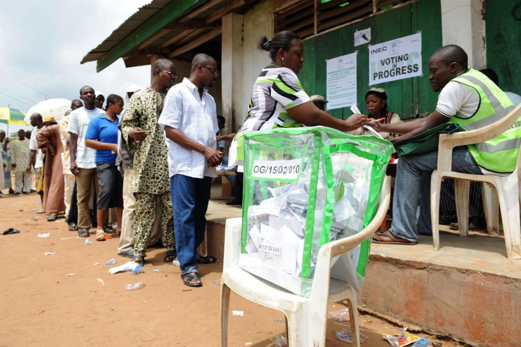 INEC officials attend to voters during an electoral process in Nigeria.